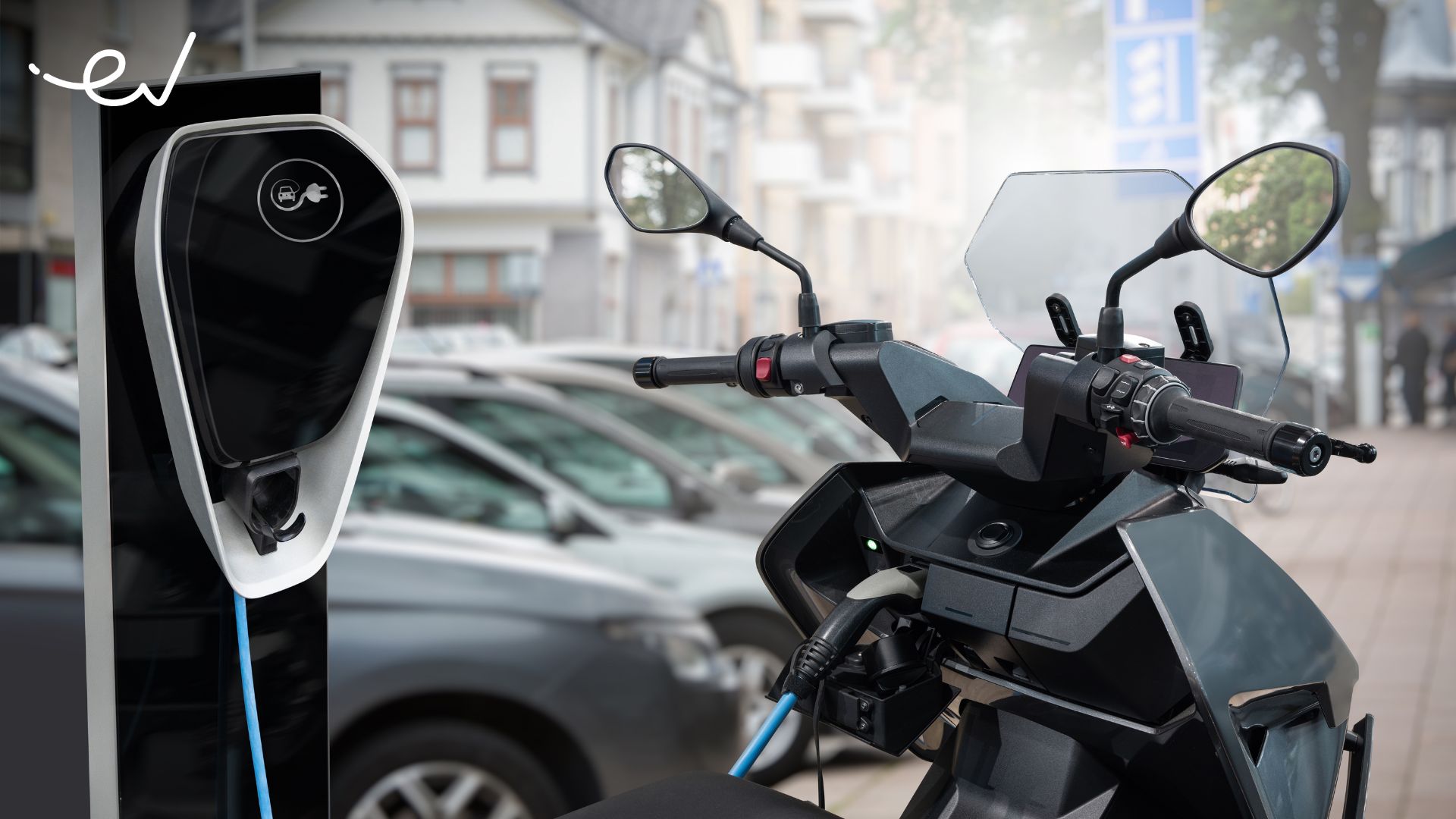 The picture shows an electric motorcycle charging at a charging station|In this picture are the founder of MAKA Motors